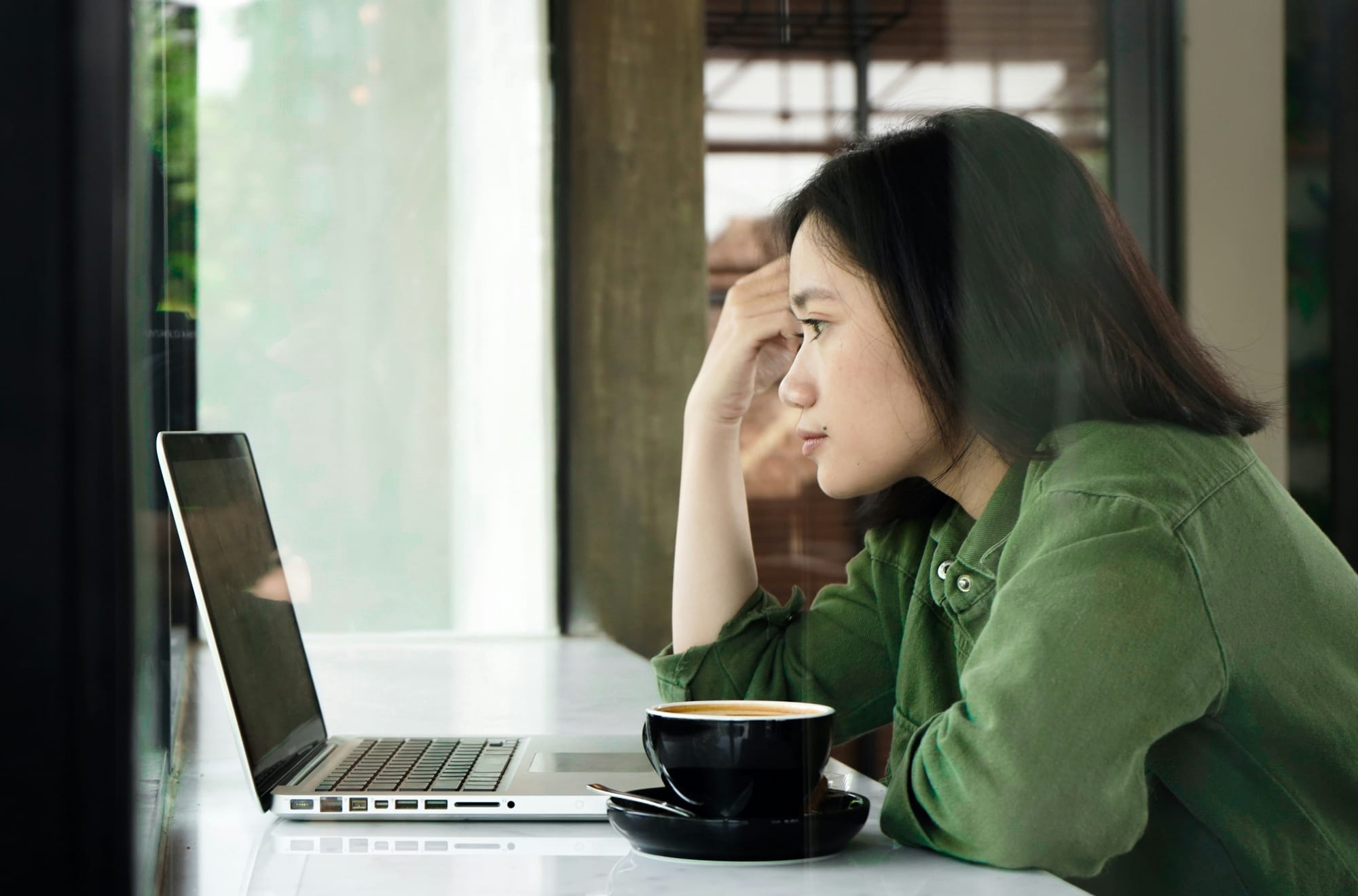 woman looking at the laptop screen - Calendly Alternatives