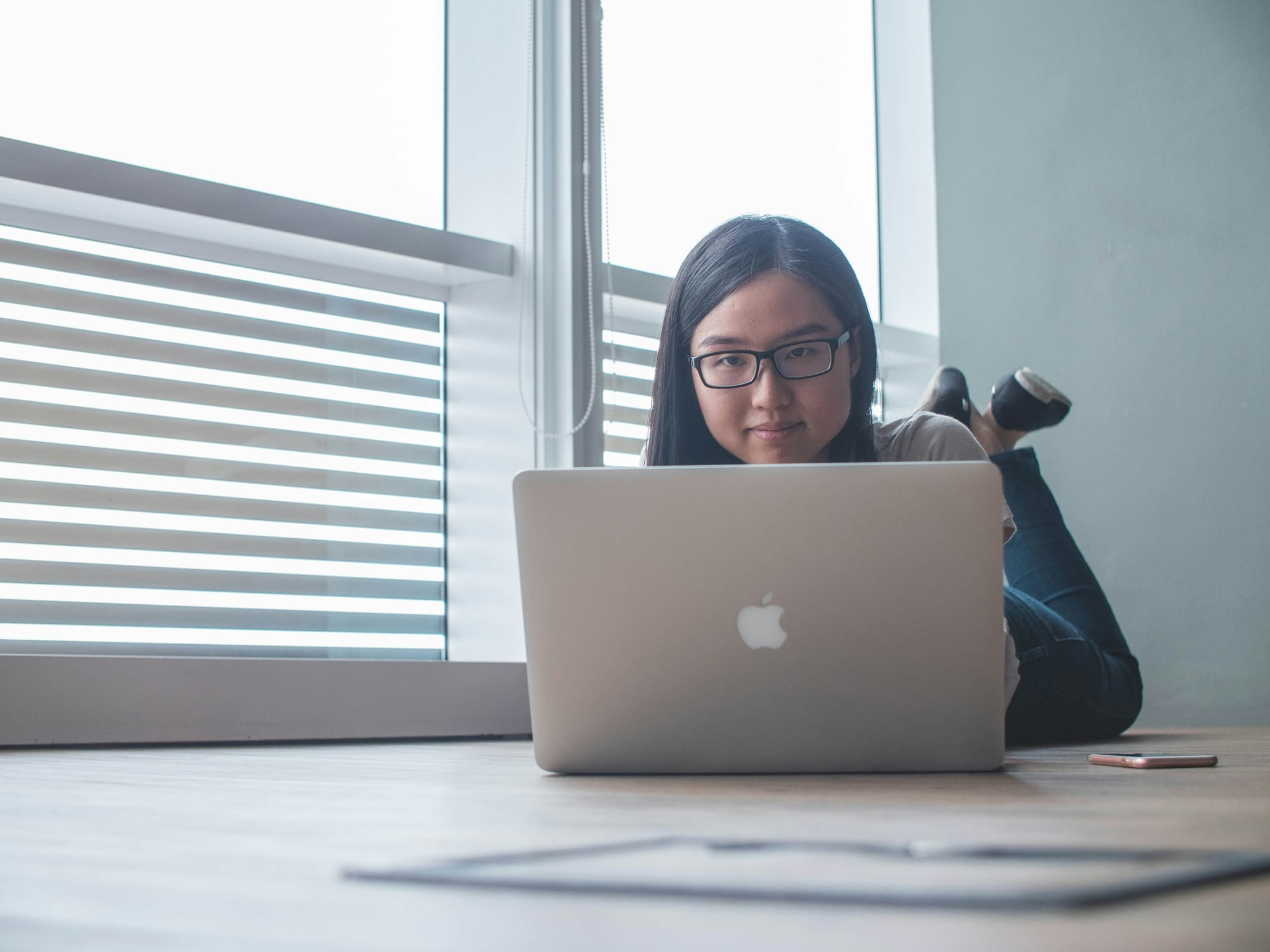 man on the floor with a laptop - AI Scheduling