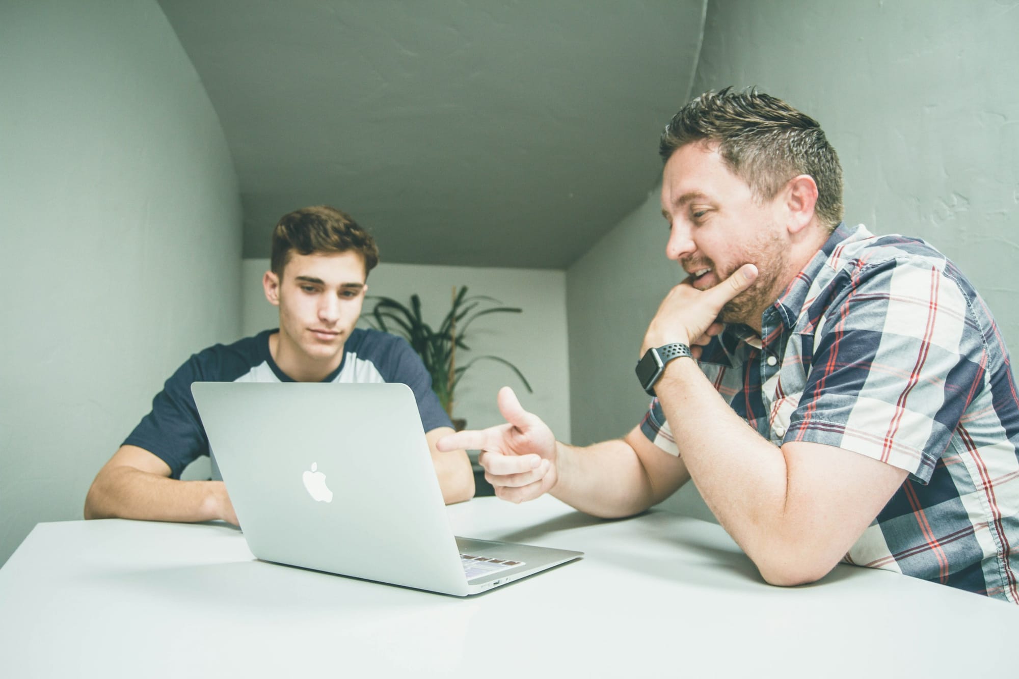 Man Pointing at Laptop - How to Use AI for Project Management