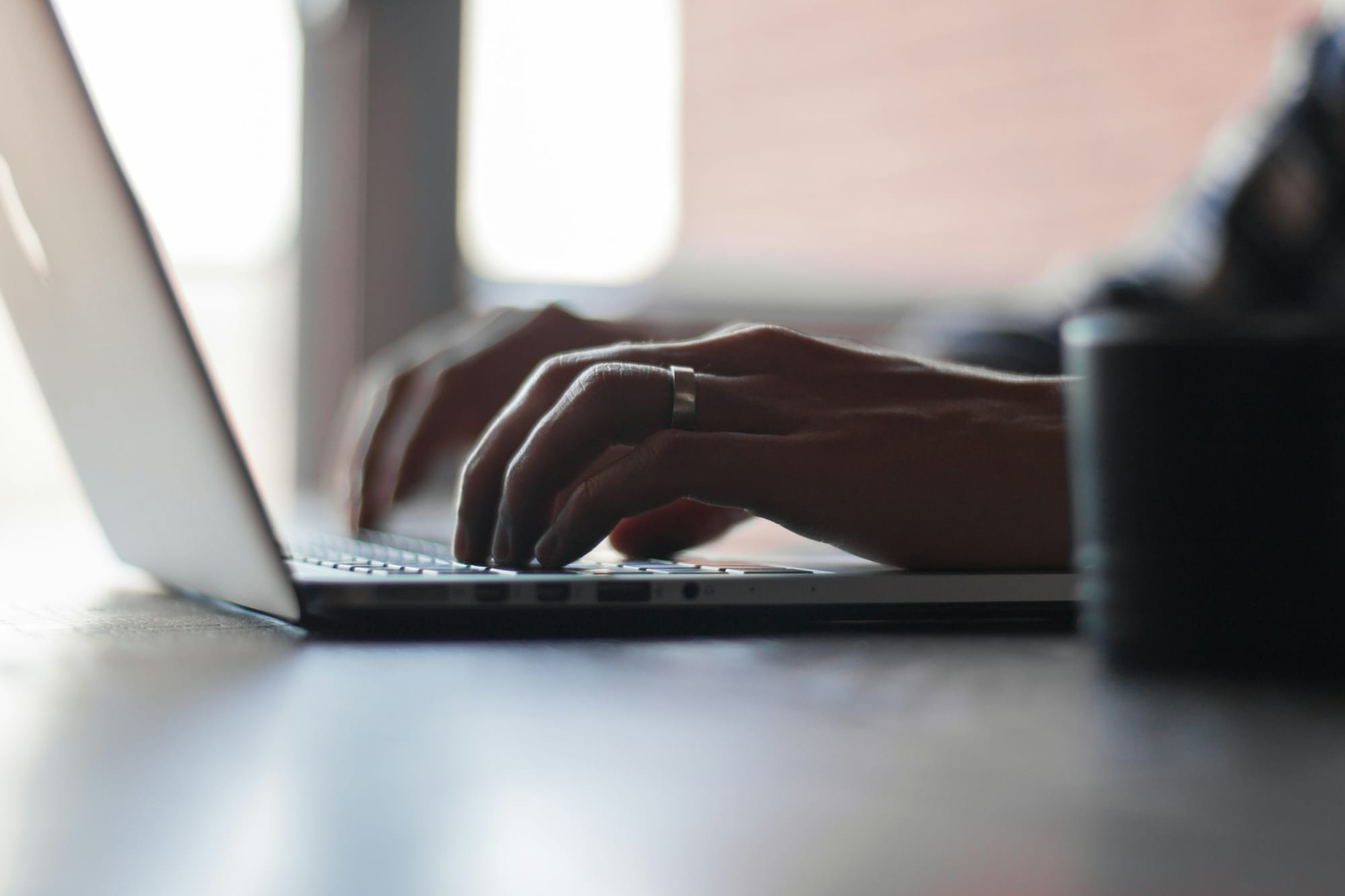 Person Working on Laptop - Factors of Productivity