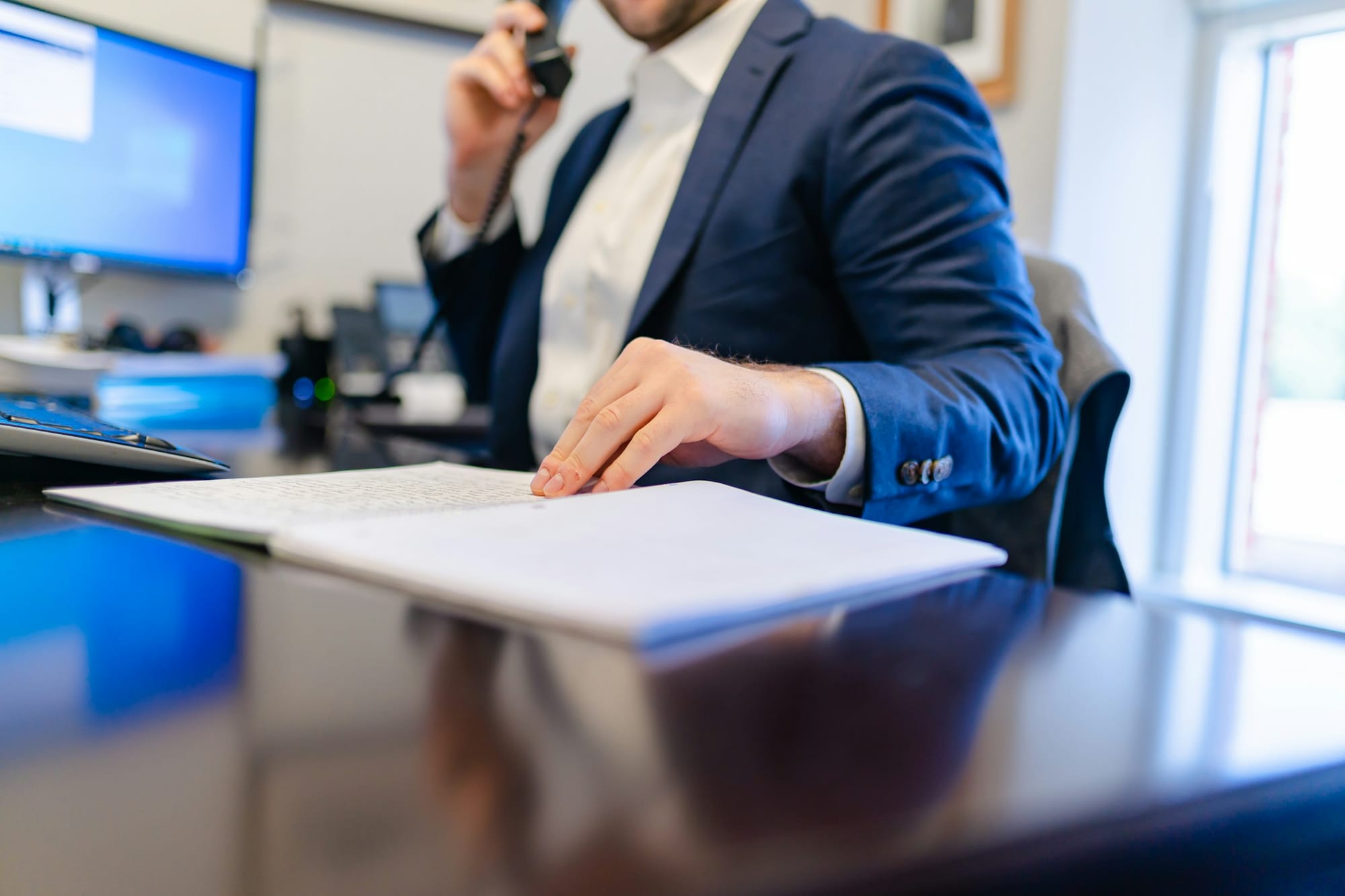Man Reading Notes - Tips for Taking Meeting Minutes
