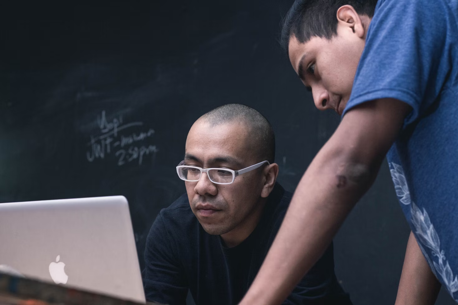 man looking at a laptop - Best AI Tools for Math Teachers