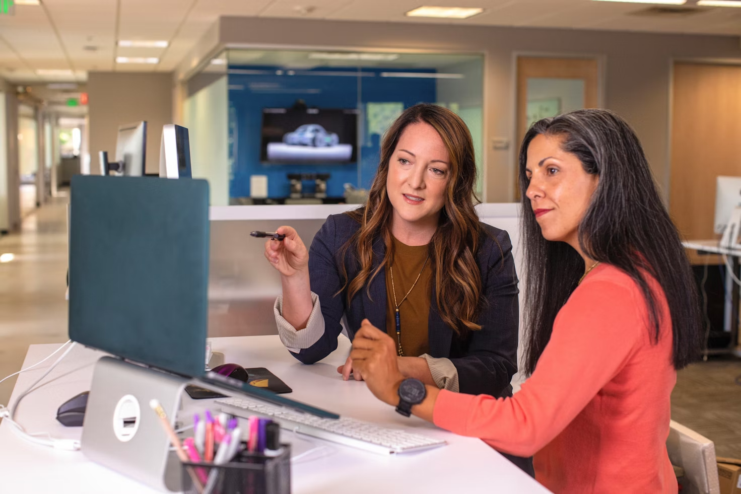 women on a laptop - Team Productivity Apps