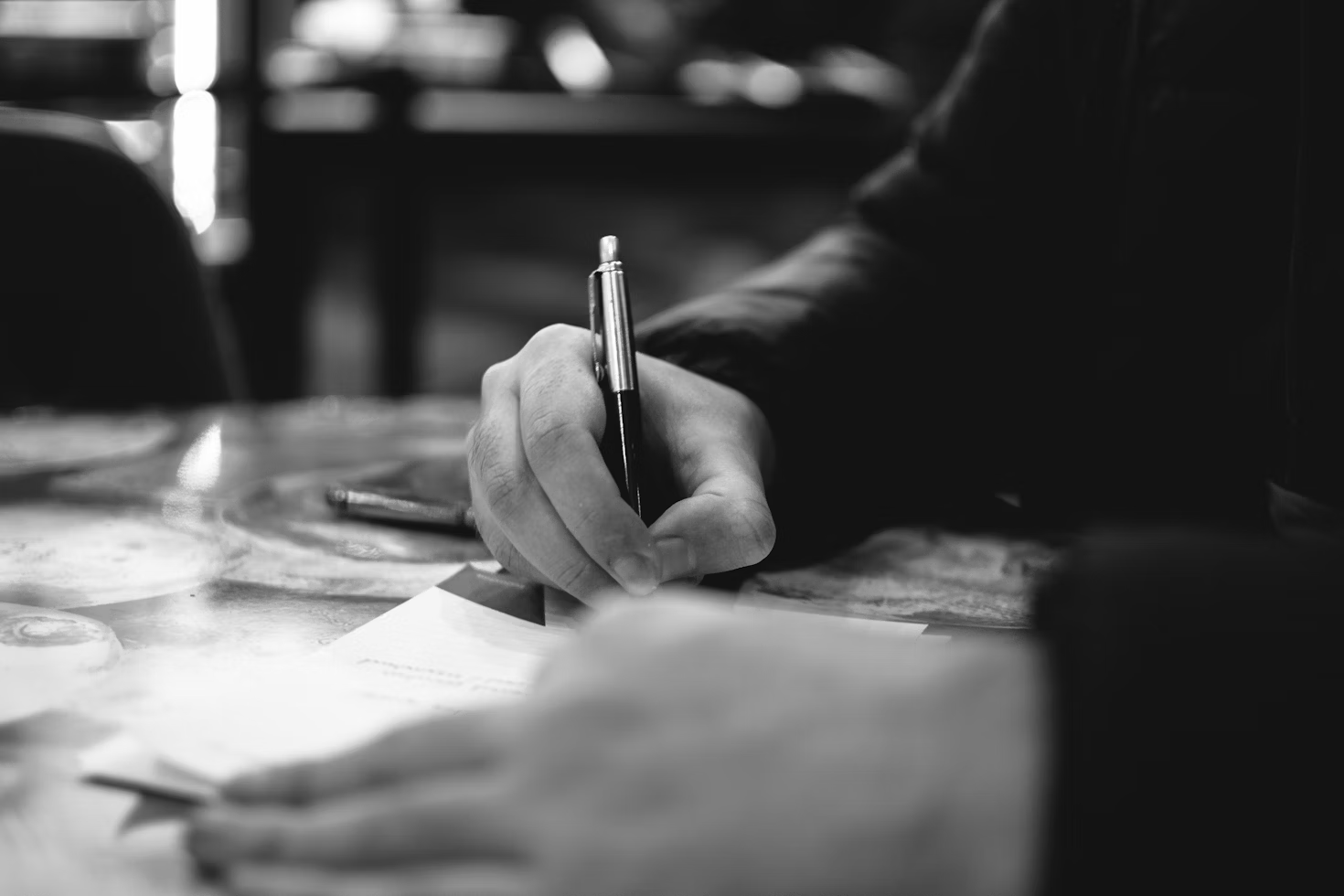 man writing - Focused Note Taking