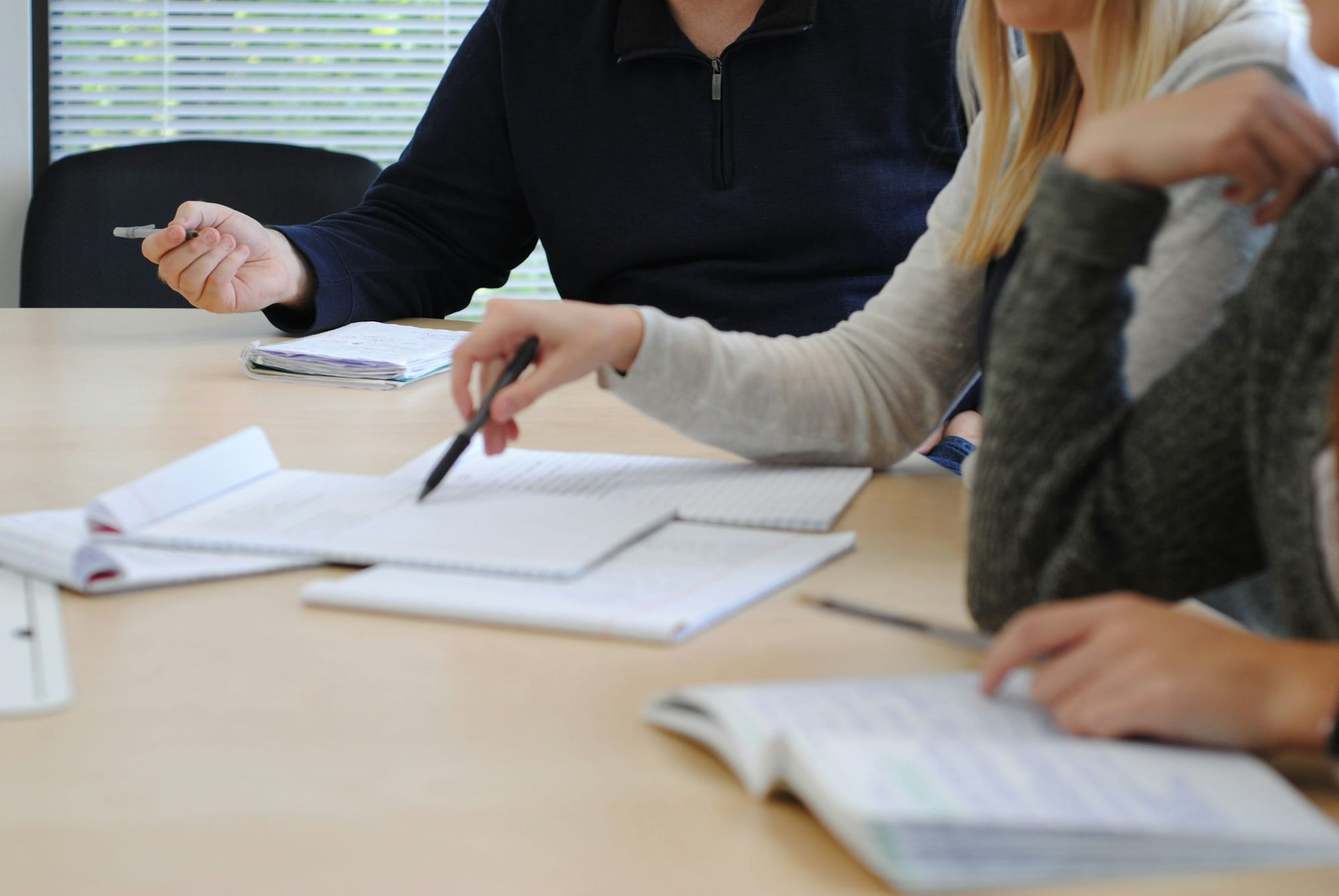 People Discussing and Taking Notes - Importance of Note Taking
