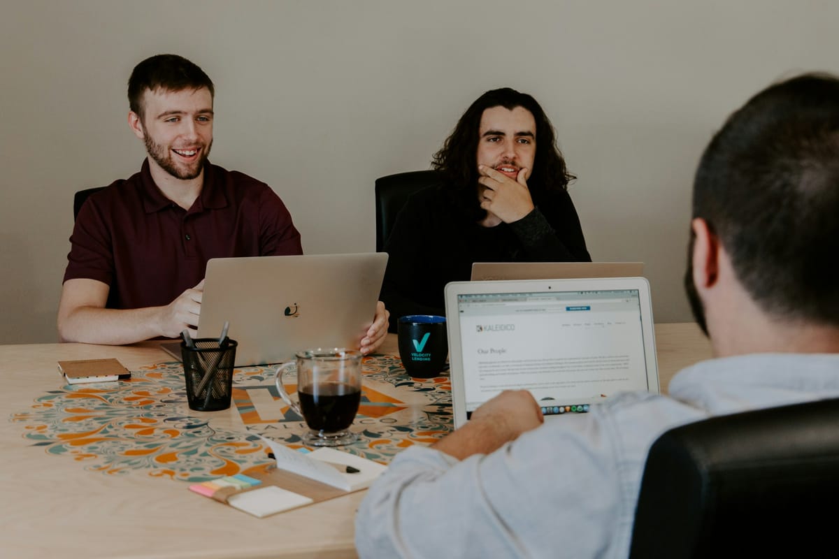 Persons in a Meeting Thinking - How to Manage Multiple Calendars