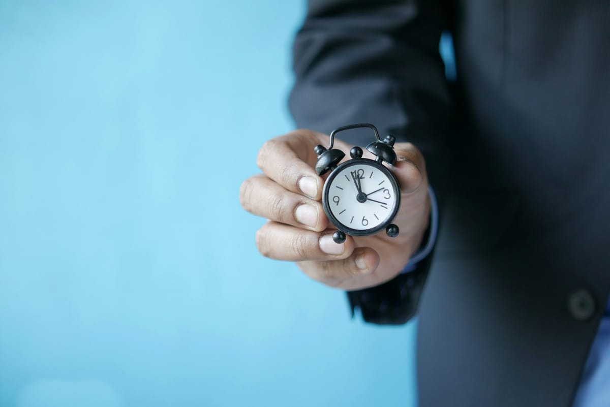 person holding a clock - Deadline Management