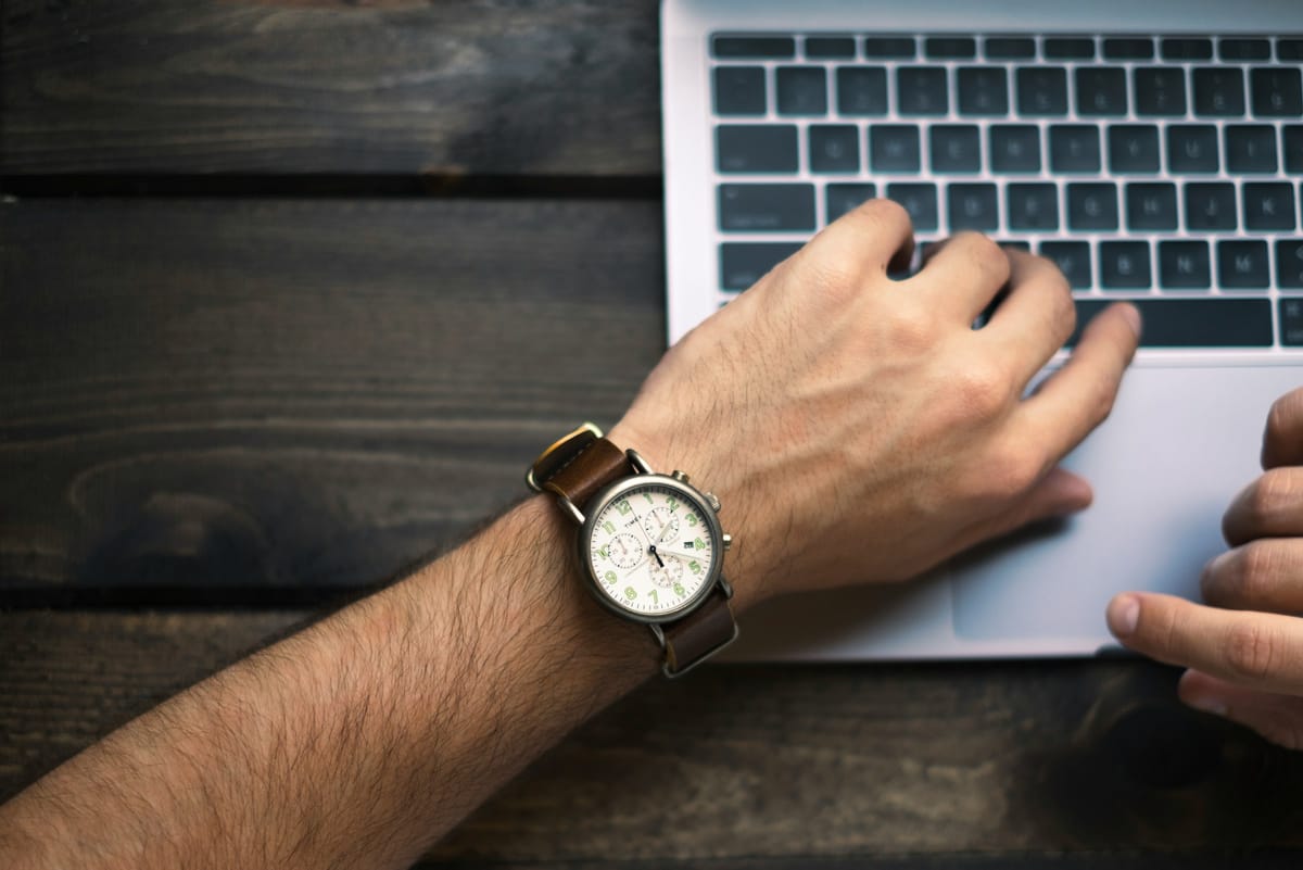 man typing on a laptop - How to Use a Calendar Effectively