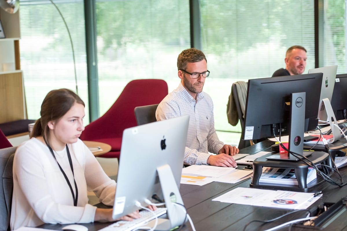 staff working in an office - AI Staff Scheduling