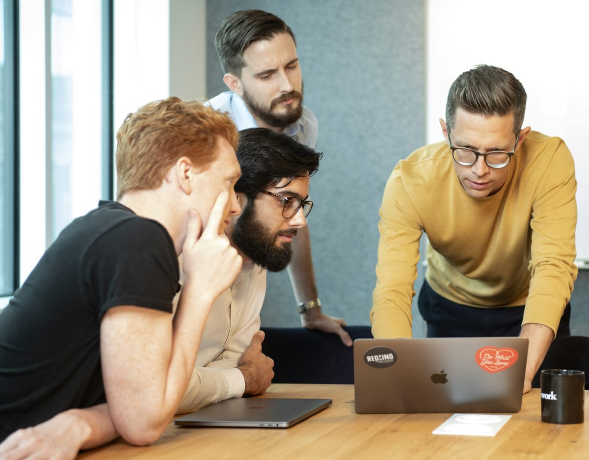 employees on a laptop -