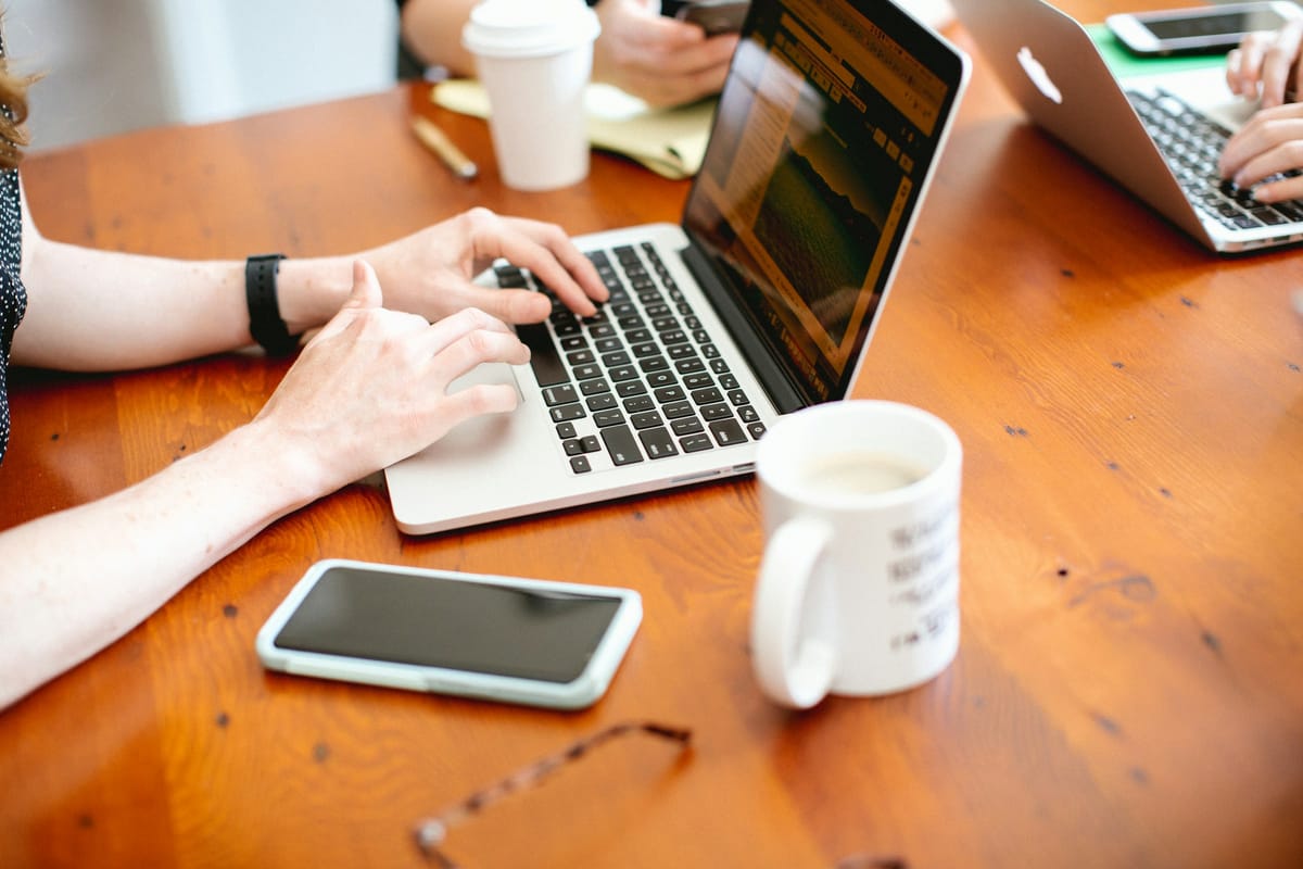 woman typing on a laptop - Best Note-Taking App for Coding