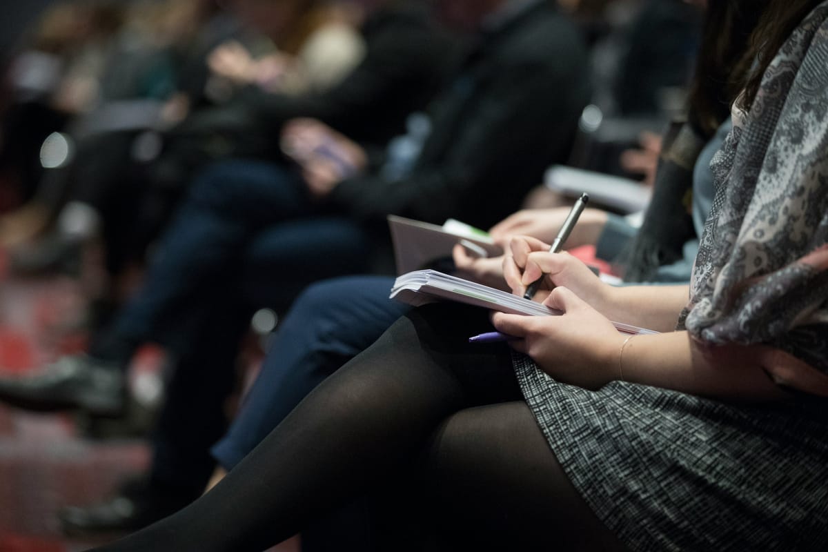 woman writing - How to Prepare Minutes of Meeting